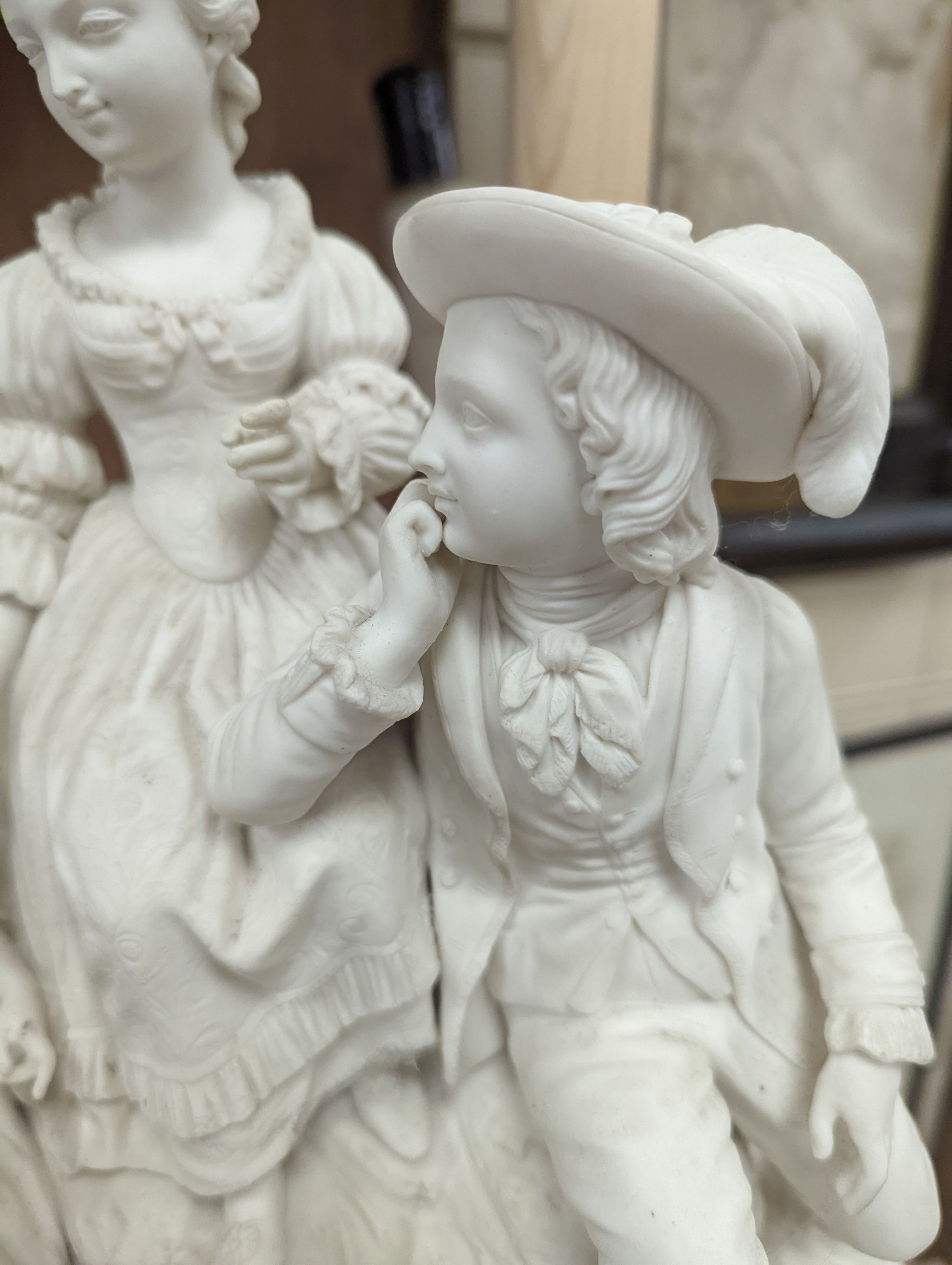 A 19th century Adams & Co. parian group of a man, woman, child and dog 31cm